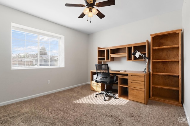 office area with baseboards, carpet floors, and ceiling fan