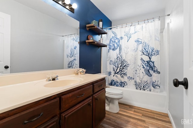 bathroom with shower / bath combination with curtain, toilet, vanity, and wood finished floors