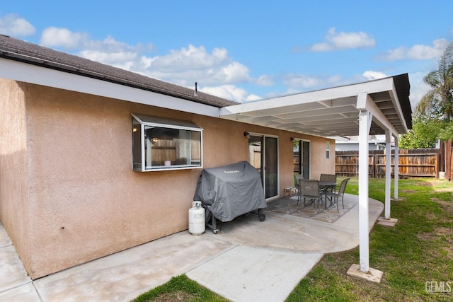 view of patio featuring grilling area and fence