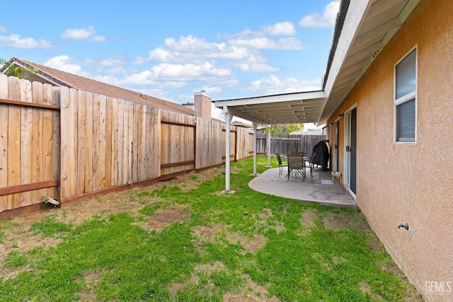 view of yard with a patio area and a fenced backyard