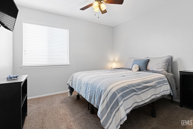 carpeted bedroom featuring baseboards and a ceiling fan