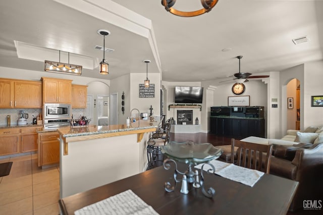 dining space featuring light tile patterned floors and ceiling fan