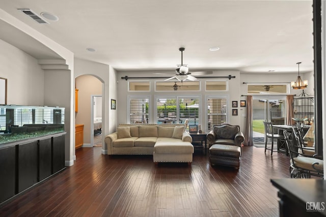 living room with dark hardwood / wood-style floors and ceiling fan