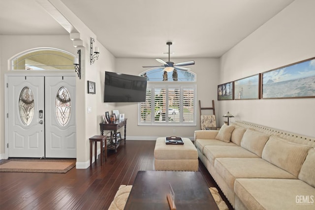 living room featuring dark wood-type flooring and ceiling fan