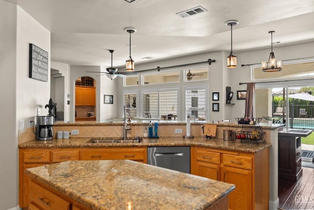 kitchen featuring pendant lighting, sink, stainless steel dishwasher, ceiling fan, and dark wood-type flooring