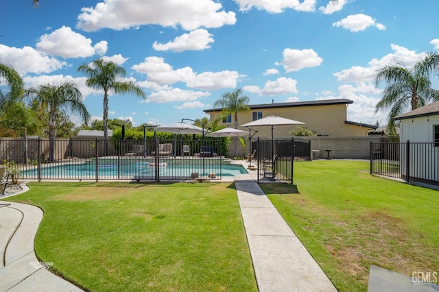 view of pool with a yard