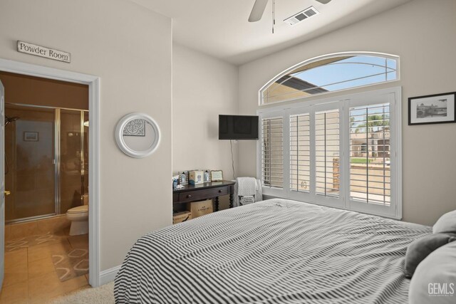 bedroom with light tile patterned flooring, ceiling fan, and ensuite bathroom