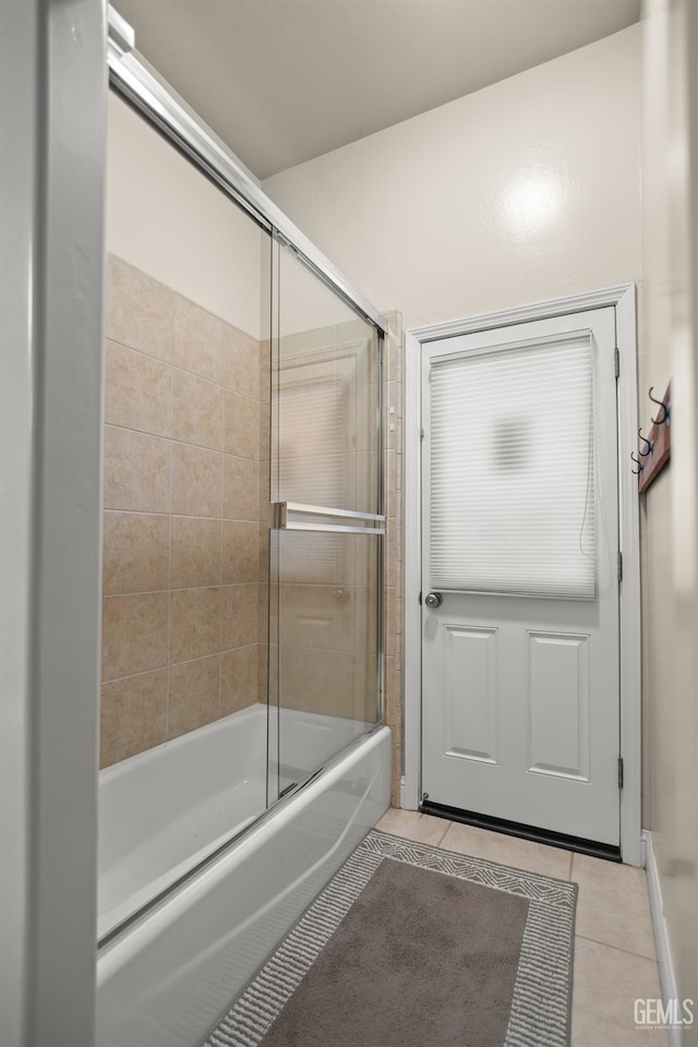 bathroom featuring enclosed tub / shower combo and tile patterned floors