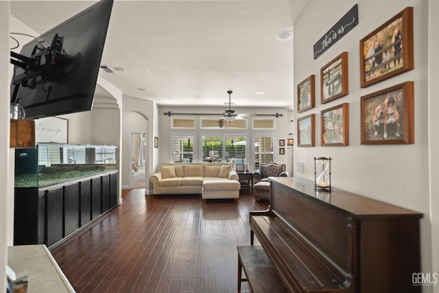 living room featuring dark hardwood / wood-style flooring and ceiling fan