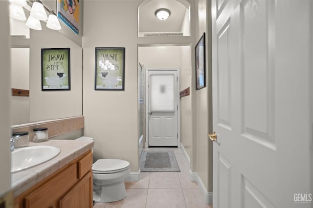 bathroom featuring vanity, toilet, and tile patterned flooring