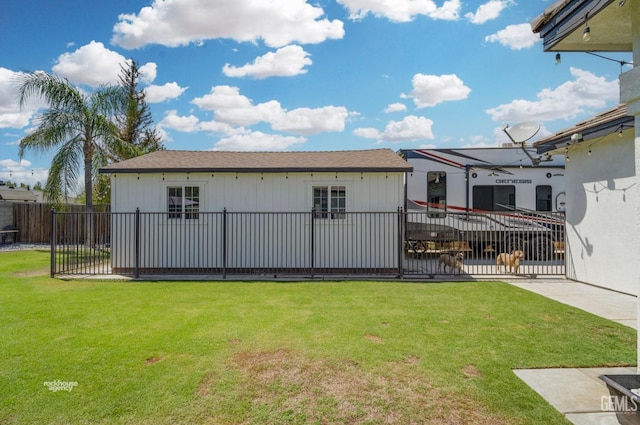 rear view of house featuring a lawn