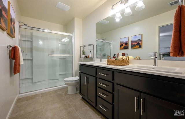 bathroom with an enclosed shower, vanity, tile patterned flooring, and toilet