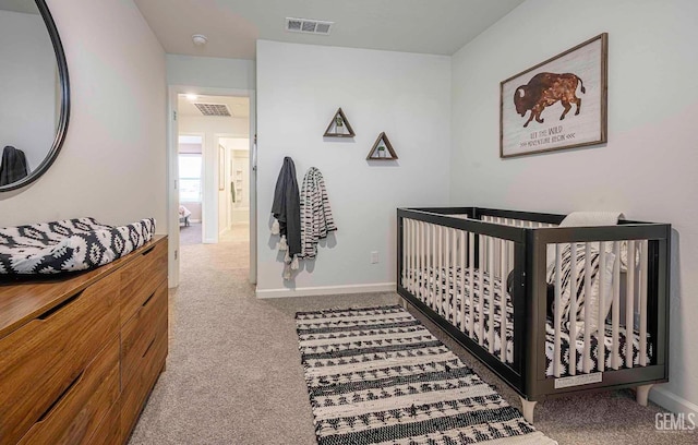 carpeted bedroom with a nursery area