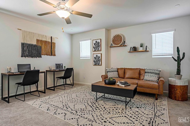 carpeted living room with ceiling fan