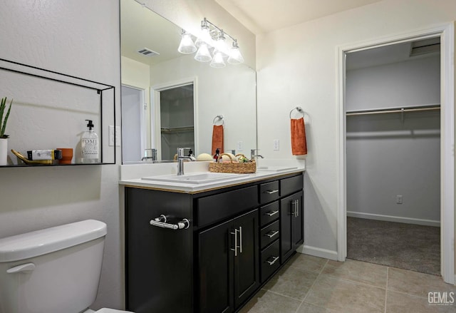 bathroom with vanity, tile patterned floors, and toilet