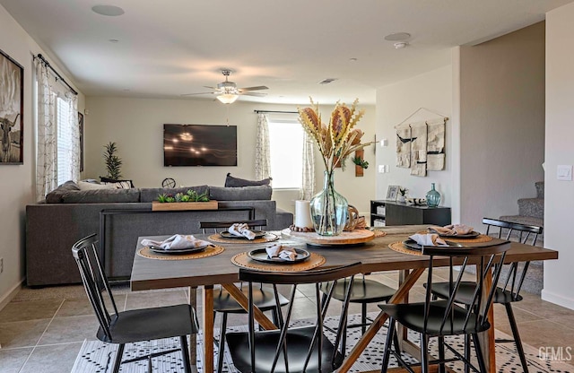 tiled dining space with a wealth of natural light and ceiling fan