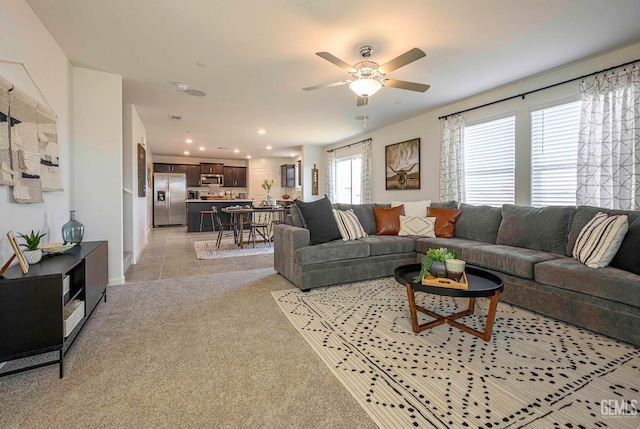 living room with ceiling fan and light carpet