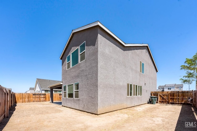 6501 Thunder Trail Dr, Bakersfield, CA 93313 - rear view of house with stucco siding, a patio, and a fenced backyard