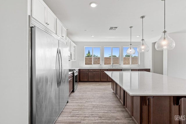 6501 Thunder Trail Dr, Bakersfield, CA 93313 - kitchen with stainless steel appliances, light wood-type flooring, recessed lighting, backsplash, and a large island