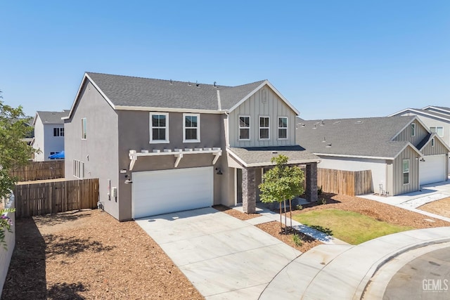 6501 Thunder Trail Dr, Bakersfield, CA 93313 - view of front of house featuring concrete driveway, board and batten siding, a garage, stucco siding, and a shingled roof