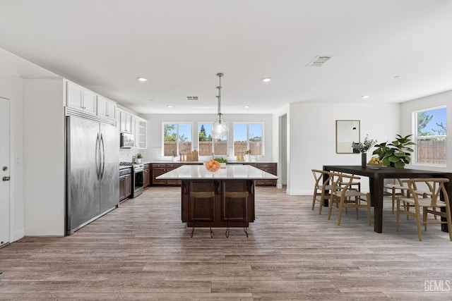 6501 Thunder Trail Dr, Bakersfield, CA 93313 - kitchen featuring appliances with stainless steel finishes, plenty of natural light, light wood-type flooring, a center island, and recessed lighting