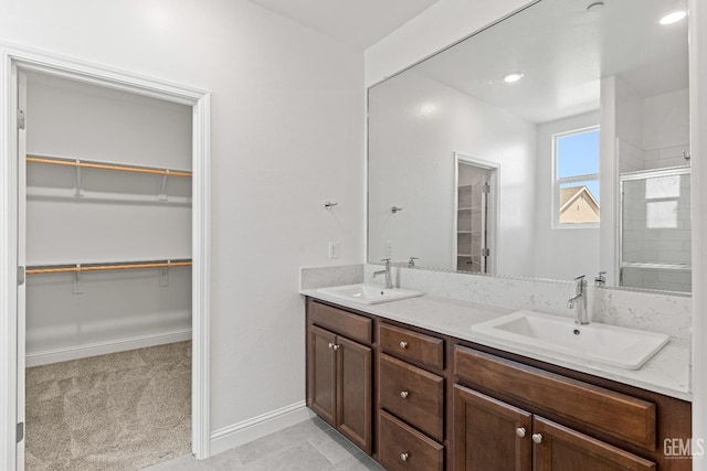6501 Thunder Trail Dr, Bakersfield, CA 93313 - full bathroom with a shower stall, double vanity, a walk in closet, and tile patterned flooring