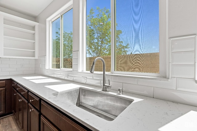 6501 Thunder Trail Dr, Bakersfield, CA 93313 - kitchen with decorative backsplash, plenty of natural light, dark brown cabinetry, and light stone countertops