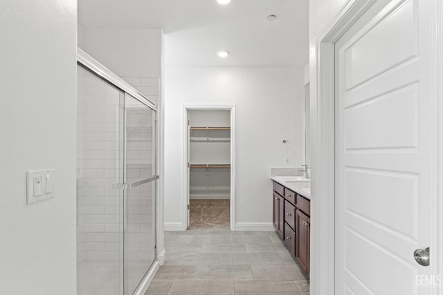 6501 Thunder Trail Dr, Bakersfield, CA 93313 - full bath with a shower stall, double vanity, a walk in closet, and recessed lighting