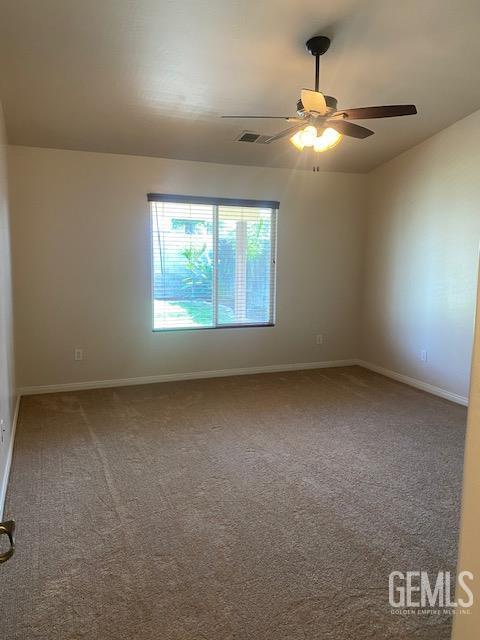 11422 Pacific Harbor Ave, Bakersfield, CA 93312 - carpeted spare room with a ceiling fan and baseboards