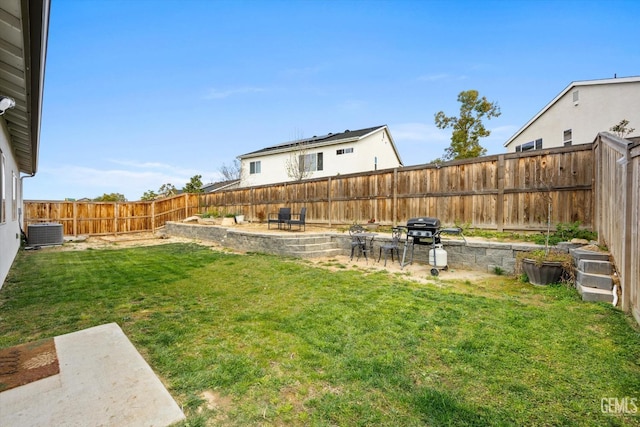 view of yard with a patio, a fenced backyard, and cooling unit