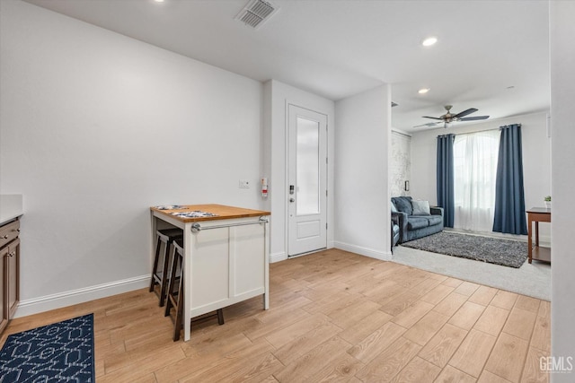 foyer featuring light wood finished floors, recessed lighting, visible vents, ceiling fan, and baseboards