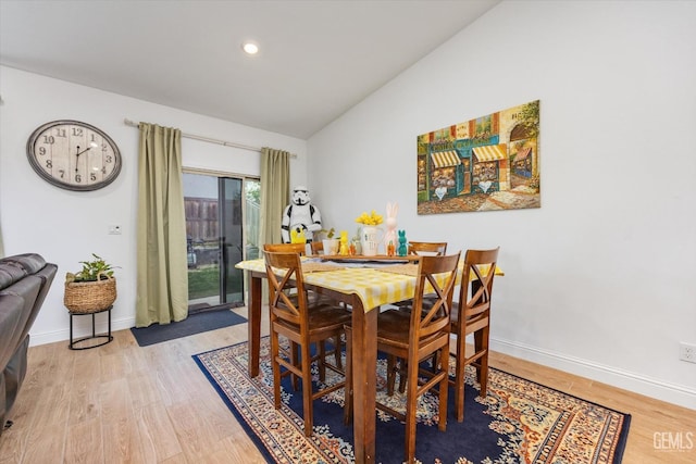 dining room with vaulted ceiling, light wood finished floors, recessed lighting, and baseboards