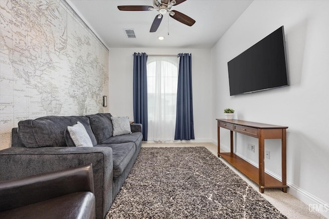 living area with recessed lighting, visible vents, an accent wall, a ceiling fan, and baseboards