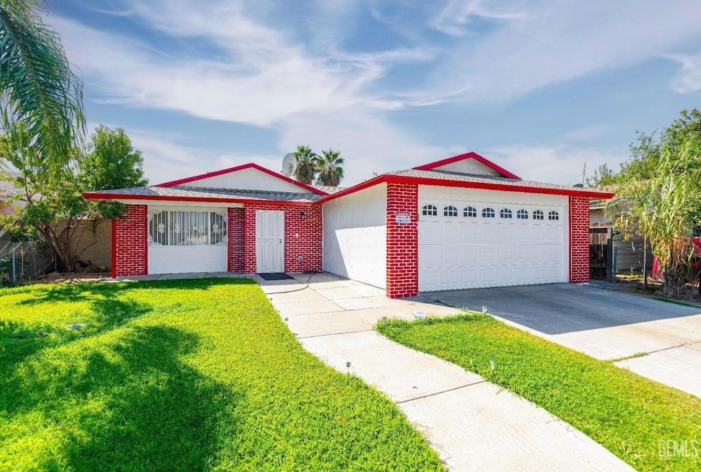 ranch-style house featuring a garage and a front lawn