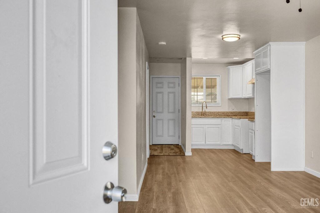 kitchen with white cabinetry, sink, and dark hardwood / wood-style floors