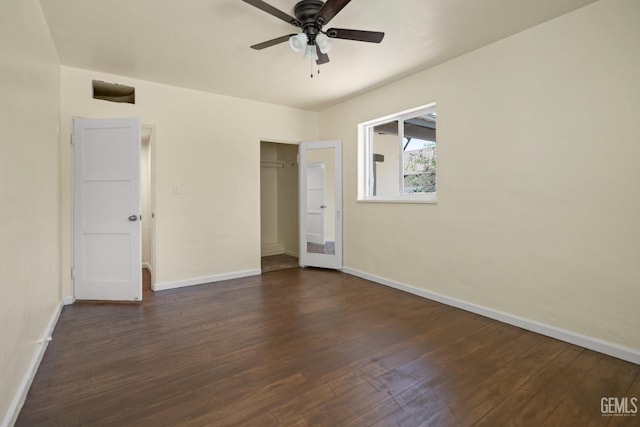 unfurnished bedroom with ceiling fan, dark wood-type flooring, and a closet