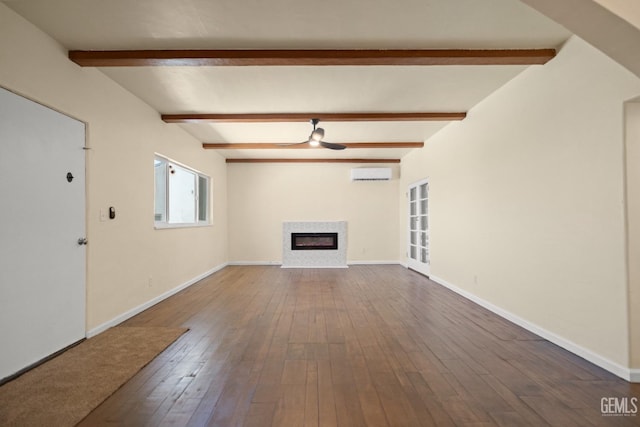 unfurnished living room featuring beam ceiling, a wall mounted AC, ceiling fan, and hardwood / wood-style floors