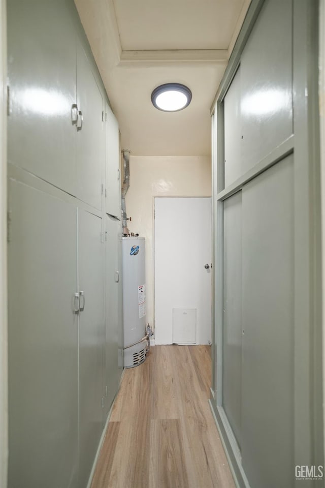 hallway featuring light hardwood / wood-style flooring and gas water heater