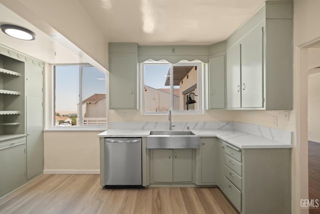 kitchen with light stone countertops, dishwasher, sink, light hardwood / wood-style flooring, and gray cabinets