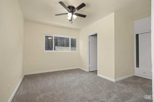 unfurnished bedroom with ceiling fan and light colored carpet