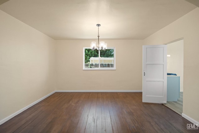 unfurnished dining area featuring dark hardwood / wood-style flooring and an inviting chandelier