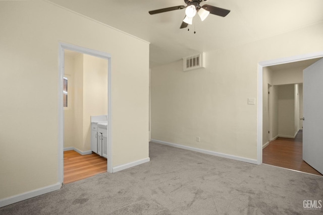 unfurnished room with ceiling fan and light colored carpet