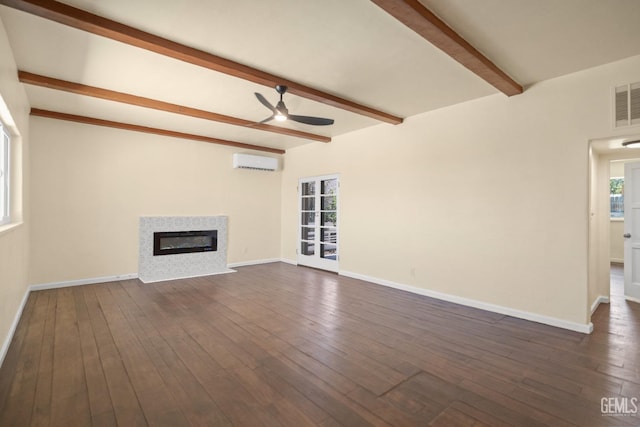 unfurnished living room with beam ceiling, ceiling fan, dark wood-type flooring, and a wall mounted air conditioner