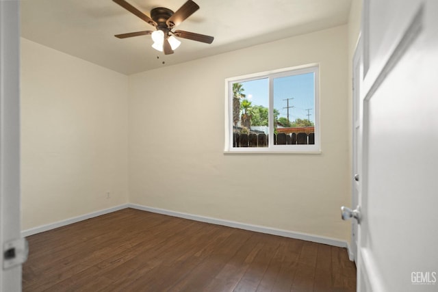 spare room featuring dark hardwood / wood-style flooring and ceiling fan