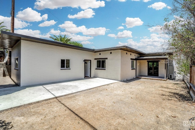 back of house with cooling unit and a patio