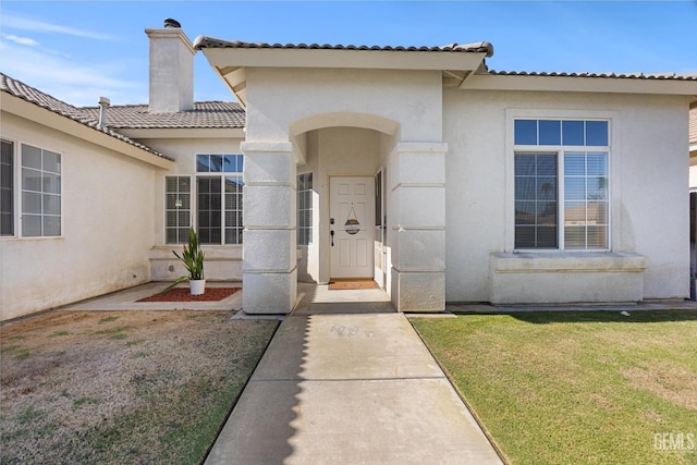 10809 Mirage Dr, Bakersfield, CA 93311 - property entrance featuring stucco siding, a chimney, a lawn, and a tile roof
