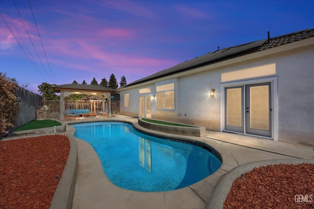 10809 Mirage Dr, Bakersfield, CA 93311 - pool at dusk with a gazebo, a fenced backyard, and a patio area