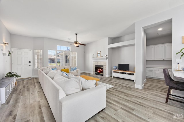 10809 Mirage Dr, Bakersfield, CA 93311 - living room with ceiling fan, light wood finished floors, a fireplace, and recessed lighting