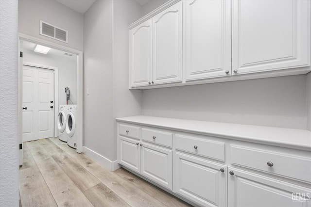 10809 Mirage Dr, Bakersfield, CA 93311 - laundry area featuring washing machine and dryer, light wood-style flooring, and cabinet space