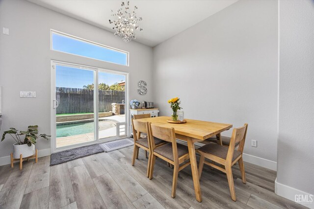 10809 Mirage Dr, Bakersfield, CA 93311 - dining space with light wood-style floors and a chandelier